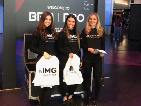 Brand ambassadors distributing goody bags at an exhibition