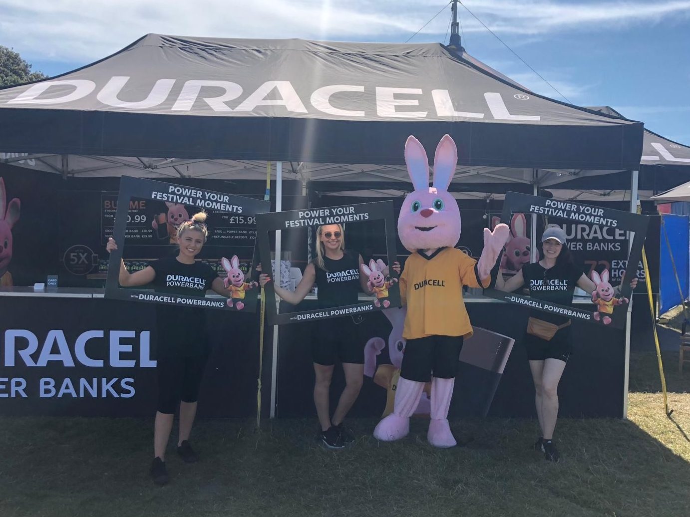 Mascot and brand ambassadors working a festival at a branded tent