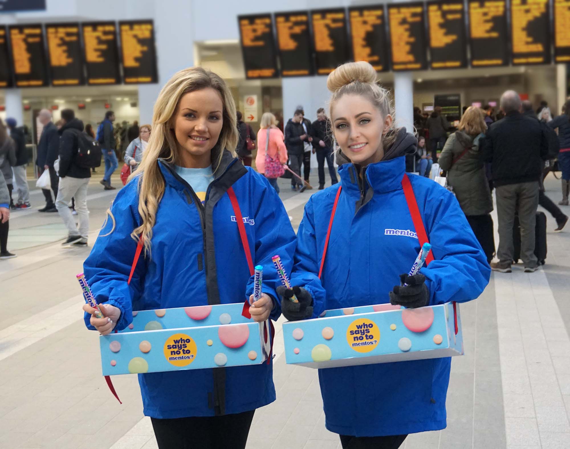 Train station sampling staff with food trays